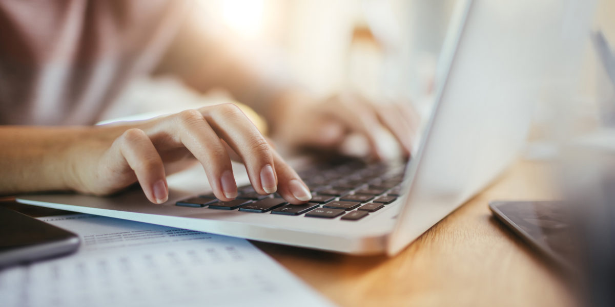 Close up of a woman using a laptop